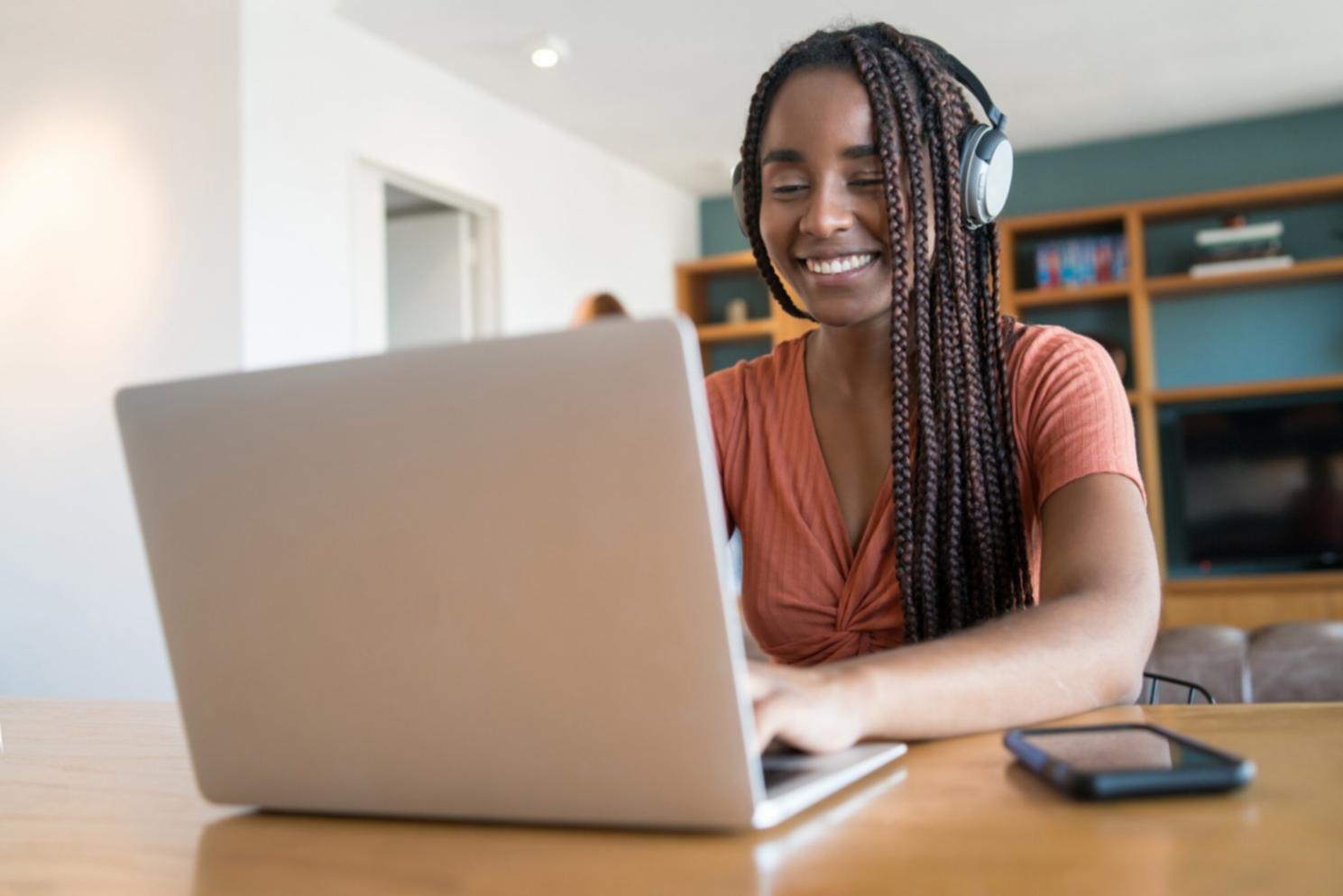 Students collaborating on coding projects in modern classroom environment